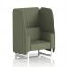 In this image, we see a sleek and modern dynamic booth with white legs. The booth features a 1 seater open design, upholstered in Main Line Flax fabric. Monument panels add a touch of sophistication to the piece, and a matching sofa can be seen in the background. Perfect for a contemporary office or lounge setting.