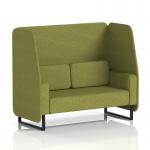 The photograph captures a stylish and modern open booth with black legs in rivet fabric, accented with olive panels and a coordinating sofa. This made-to-order piece from Dynamic Booths offers both functionality and aesthetic appeal.