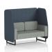 The picture captures a stylish and modern open booth, with sleek black legs and unique rivet fabric. The booth features two comfortable seats and crucible panels, along with a prime sofa. This customizable design is perfect for any space.
