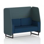 The picture shows a modern, customizable booth with sleek black legs and geometric paneling in multiple fabrics. This 2-seater design is perfect for creating a dynamic seating arrangement in any space.