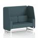 The photo captures a sleek, modern open booth with white legs featuring dynamic polygon panels and a comfortable 2-seater sofa. The custom-made design adds a unique touch to any space.
