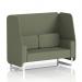 This image showcases a stylish and versatile 2-seater open booth with white legs, upholstered in a neutral Main Line Flax fabric. The modular design allows for dynamic arrangements, while the elegant monument panels add visual interest. The comfortable sofa invites relaxation and conversation.