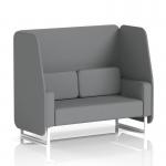 This photo features a sleek and modern Dynamic Booths open booth in Brixworth design. The 2 seater sofa has white legs and is upholstered in a stylish Synergy fabric. Partner panels and a matching sofa complete the look.