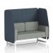 This image shows a sleek and modern Dynamic Booths 2-seater open booth with white legs, crafted in Brixworth and upholstered in unique Rivet fabric. The booth features striking Crucible panels and is complemented by a stylish Prime Sofa.