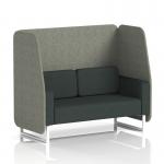 This photograph features a dynamic booth made to order with a white leg design and open seating for two in rivet fabric. The booths vitreous panels and charcoal sofa provide a sleek and contemporary look. Light streams in through the windows, creating a welcoming and modern atmosphere.