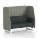 This photograph features a dynamic booth made to order with a white leg design and open seating for two in rivet fabric. The booths vitreous panels and charcoal sofa provide a sleek and contemporary look. Light streams in through the windows, creating a welcoming and modern atmosphere.