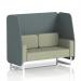 This photograph features a stunning handmade 2 seater open booth with white legs, upholstered in stylish Main Line Flax fabric. The booth is unique with its Westminster panels and complemented by a Newbury Sofa for added comfort. The overall look is modern and elegant.