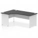 In this photograph, you see a sleek and modern office desk with a 1800mm left crescent shape. The desk features a black top and white panel end leg, giving it a dynamic and professional appearance. This desk is perfect for any modern workplace setting.