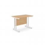 The photograph shows a modern office space with a rectangular desk made of beech wood and white metal legs. The desk measures 1000mm x 600mm and is sleek and stylish, perfect for any contemporary office setting. The clean lines and neutral colors make it a versatile piece of furniture.