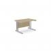 The image shows a sleek and modern office space, with rectangular desks in a stylish urban oak finish. The desks feature twin bar metal legs for stability and measure 1200mm x 800mm. This efficient and functional workspace is perfect for a professional setting.