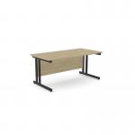 The picture shows a sleek and modern office space with two ashford twin bar metal leg desks. The desks are rectangular and measure 1600mm x 800mm, featuring a straight design for easy placement. The desks are finished in urban oak and black for a stylish look.
