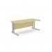 The photo features a modern office space with sleek, rectangular ashford twin bar metal leg desks. The desks are 1800mm x 800mm in size and have a maple finish with silver metal legs. The open concept design and clean lines add a touch of sophistication to the workspace.