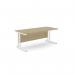 The photo shows a spacious office with multiple rectangular desks. The desks have sleek, metal legs and a sophisticated blend of urban oak and white finishes. These 1800mm x 800mm desks offer ample workspace for productivity and organization.