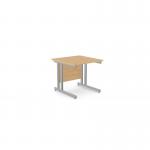 In the photograph, there are two rectangle desks made of beech wood with silver metal legs. The desks are placed side by side, one facing towards the camera and the other facing away. The surfaces of the desks are clear of clutter, with only a few papers and a computer monitor visible. The room is well-lit and modern, with white walls and sleek, silver accents.