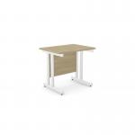 The photograph displays a clean and modern office space with sleek, rectangular desks. The desks feature a sophisticated urban oak finish and are supported by sturdy twin bar metal legs. The 800mm x 600mm size is perfect for a minimalist and functional work environment.