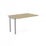 The photo shows a modern office bench desk with add-on units. The sleek urban oak finish is complemented by a silver portal top, creating a stylish and functional workspace for one person. The desktop measures 1200 x 800, making it a perfect fit for any office.