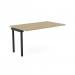 This photo features an office bench desk with add-on units in a sleek urban oak finish. The add-on portal top measures 1400 x 800 and is accented with black details. Perfect for a modern and efficient workspace for one person.