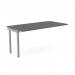 The picture shows a modern office scene with a sleek, graphite-colored bench desk. On top of the desk are add-on units for organization. The clean lines and minimalist design of the C-sense 1 person bench add-on create a stylish and functional workspace.