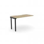 The Edit Office bench desk add-on unit features a sleek and modern design with a scalloped top. This unit is designed for one person and measures 1200 x 600. The urban oak finish and black accents give it a stylish and professional look.