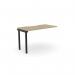 The Edit Office bench desk add-on unit features a sleek and modern design with a scalloped top. This unit is designed for one person and measures 1200 x 600. The urban oak finish and black accents give it a stylish and professional look.