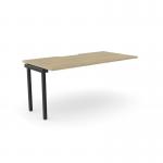 This photograph features a sleek and modern office bench desk, with add-on units and a scallop top measuring 1600 x 800. The desk is finished in urban oak and black, creating a stylish and professional workspace for one person.