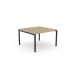 The image shows a modern office bench with an open leg design, featuring a scallop top and a sleek urban oak finish. Measuring 1000 x 600, it is designed to accommodate one person comfortably. Its black accents add a touch of sophistication to any workspace.