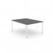 The picture showcases a contemporary office space with a sleek desk setup. The open-leg bench desking system features a scalloped top and graphite color, accented by a crisp white finish. The single person desk measures 1000 x 800, providing ample workspace.