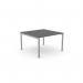 In the picture, there is a sleek and modern office bench desking featuring open legs and a scalloped top. The surface measures 1200 x 600 and has a graphite finish with silver accents. It comfortably accommodates 1 person and adds a touch of sophistication to any workspace.
