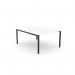 The photo features a sleek and modern office bench with an open leg design and scallop-shaped top. It is designed for one person and measures 1200 x 800. The color scheme is white and black, adding a touch of sophistication to any office space.