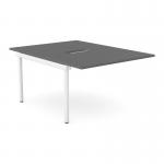 The image shows a modern and sleek office bench desk with add on units, designed for two people. The desk has a scallop top and is colored graphite with white accents.