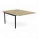 This photo features two sleek C-sense bench desk add-on units, with scalloped tops, in a chic Urban Oak finish. The units are designed to comfortably accommodate two people and measure 1200 x 800. The sophisticated black legs provide a modern contrast against the warm wood tone.