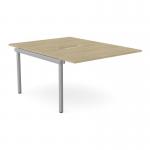 The photograph shows an urban oak desk with add-on units for a C-sense 2 person bench. The scallop top measures at 1200 x 800 and is sleekly designed with a silvery finish. Perfect for any modern office space.