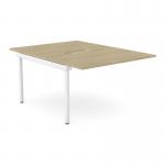 On a neutral colored wood desk, there are two separate add-on units that easily attach to the main desk. The sleek scalloped edges add a modern touch. The desk is set up for two people and the color scheme is a combination of urban oak and white.