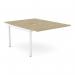 On a neutral colored wood desk, there are two separate add-on units that easily attach to the main desk. The sleek scalloped edges add a modern touch. The desk is set up for two people and the color scheme is a combination of urban oak and white.