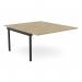 This photo shows a modern and sleek C-sense 2 person bench add-on desk unit in urban oak with a black scallop top. Perfect for adding extra workspace to your office bench desk.