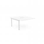 The picture shows a sleek, white desk with an add-on unit for two people to work comfortably. The desk has a scallop top and measures 1400 x 800. This C-sense office bench desk is functional and modern, perfect for a productive workspace.
