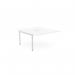 The picture shows a sleek, white desk with an add-on unit for two people to work comfortably. The desk has a scallop top and measures 1400 x 800. This C-sense office bench desk is functional and modern, perfect for a productive workspace.