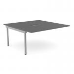 The picture shows a sleek graphite colored office bench desk with add-on units, featuring a scalloped top for added style. It can comfortably accommodate two people and has dimensions of 1600 x 800. Silver accents add a touch of modernity to the design.