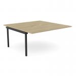 The photo shows a sleek modern office bench desk with add-on units, featuring a scallop-shaped top. The 2-person desk is 1600 x 800 in size and has a chic urban oak and black finish. Perfect for any office setting.