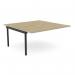 The photo shows a sleek modern office bench desk with add-on units, featuring a scallop-shaped top. The 2-person desk is 1600 x 800 in size and has a chic urban oak and black finish. Perfect for any office setting.