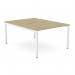 The picture shows a stylish and modern office bench desking setup. It features a C-sense 2 person bench with open legs and a scalloped top in a 1200 x 800 size. The color of the wood is urban oak with accents of white. The clean and sleek design would be perfect for any contemporary workspace.