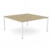 In the picture, you can see a spacious office bench desking setup designed for two people. The open leg design and scallop top add a modern touch, while the urban oak finish gives it a sleek and professional appearance.
