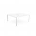 In the image, two people are sitting at a white open-leg bench desking system. The scallop-shaped top of the desk measures 1600 x 800 and is surrounded by a clean, modern office environment. This bench is part of the C-sense line and has a professional, sleek appearance.