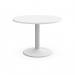 The photograph shows the Kito meeting table with a 1000mm round white top and a cylinder base in white. The office space is organized and professional, with chairs neatly placed around the table. The table appears sturdy and sleek, perfect for a productive meeting.