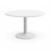 The image shows a white round table with a cylinder base in an office meeting room. The table is surrounded by chairs and has books and papers placed on it. A laptop and coffee cup can also be seen on the table.