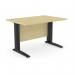 The image shows a spacious office with sleek, rectangular desks. The metal legs of the desks add durability while the maple finish brings a touch of warmth to the space. A simple yet functional design perfect for any modern workplace.
