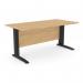 This picture shows a modern and sleek office space with rectangular desks featuring Komo metal legs. The desks are 1600mm x 800mm in size and have a straight design. They are made of beech wood with black accents, creating a sleek and professional look.