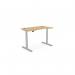 The image shows a modern office set up with a round Sit Stand and Height Adjustable Desk. The desk has a curved Bamboo top and a sleek Silver frame. Perfect for a stylish and ergonomic workspace.