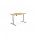 This photo shows an office set up with a Sit Stand and Height Adjustable desk. The desk has a rectangular Bamboo top with a silver frame, measuring 1200x700mm. This versatile desk allows for both sitting and standing positions, providing ergonomic benefits for the user. #OfficeDesk #SitStand #HeightAdjustable