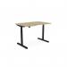 In the photo, we see a sleek and modern office space with a round sit-stand desk. The desk features a scalloped design and measures 1200 x 800mm. It has a stylish urban oak top and a black frame. The height of the desk can be easily adjusted, making it a versatile and practical addition to any workspace.